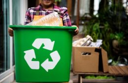 African Descent Kid Holding Recycling Box of Plastic Bottles