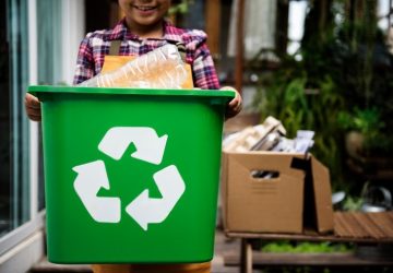 African Descent Kid Holding Recycling Box of Plastic Bottles