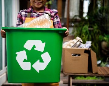 African Descent Kid Holding Recycling Box of Plastic Bottles