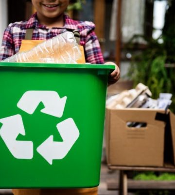 African Descent Kid Holding Recycling Box of Plastic Bottles