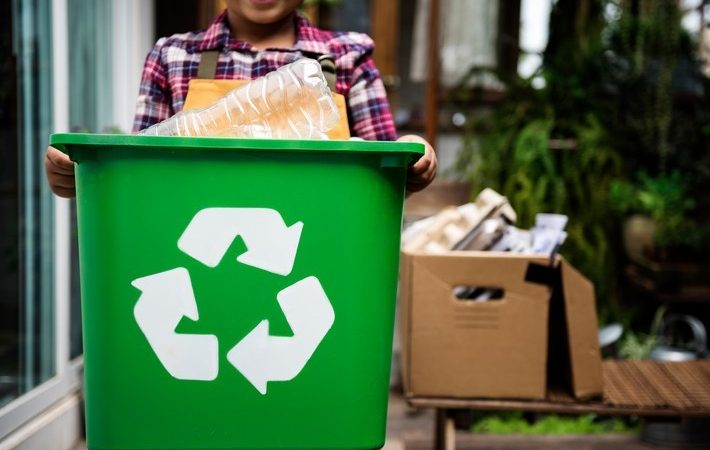 African Descent Kid Holding Recycling Box of Plastic Bottles